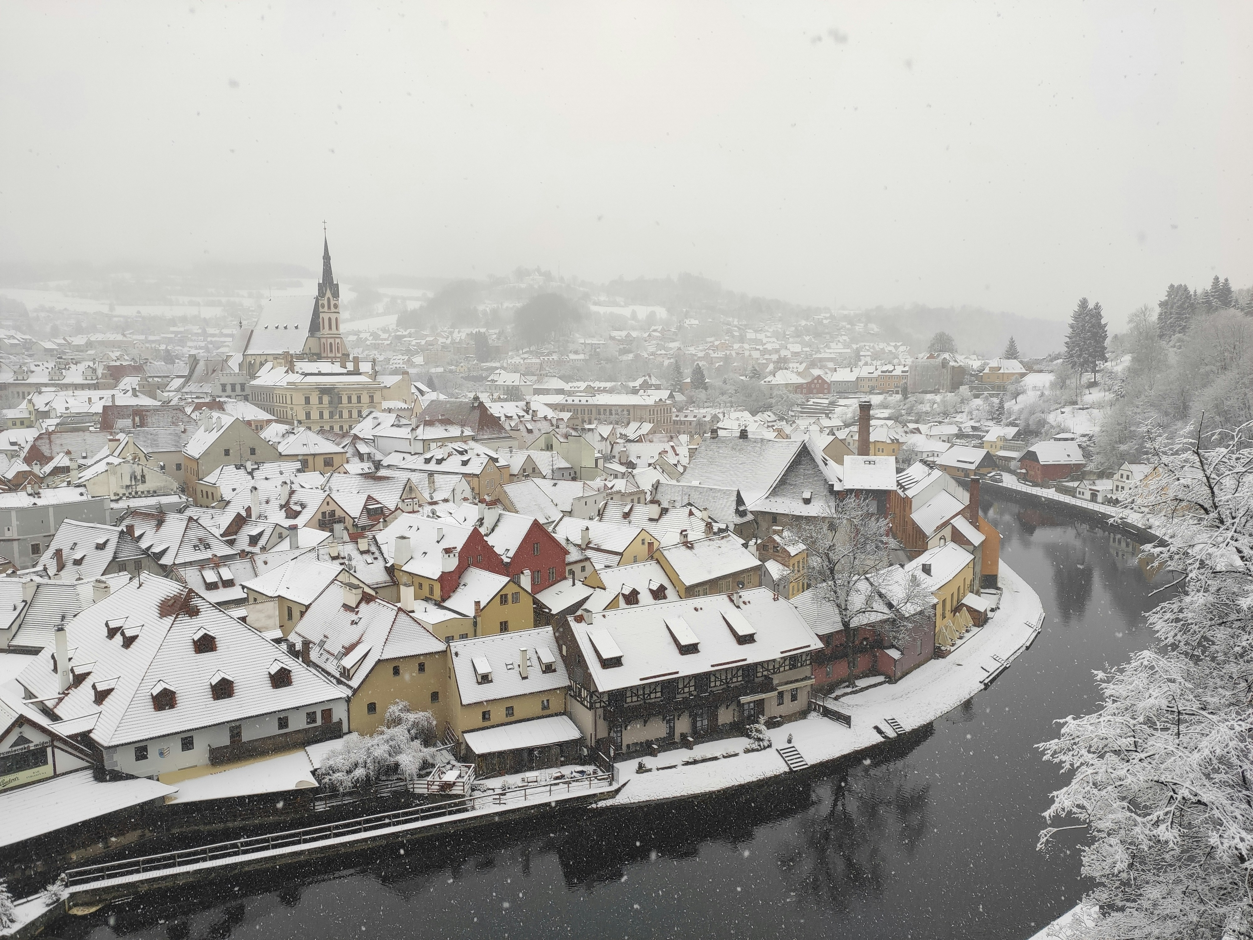 a river running through a snow covered town