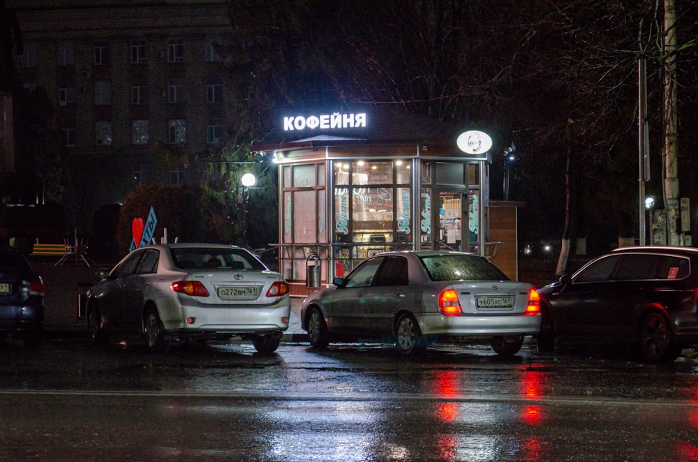 a couple of cars parked in front of a building