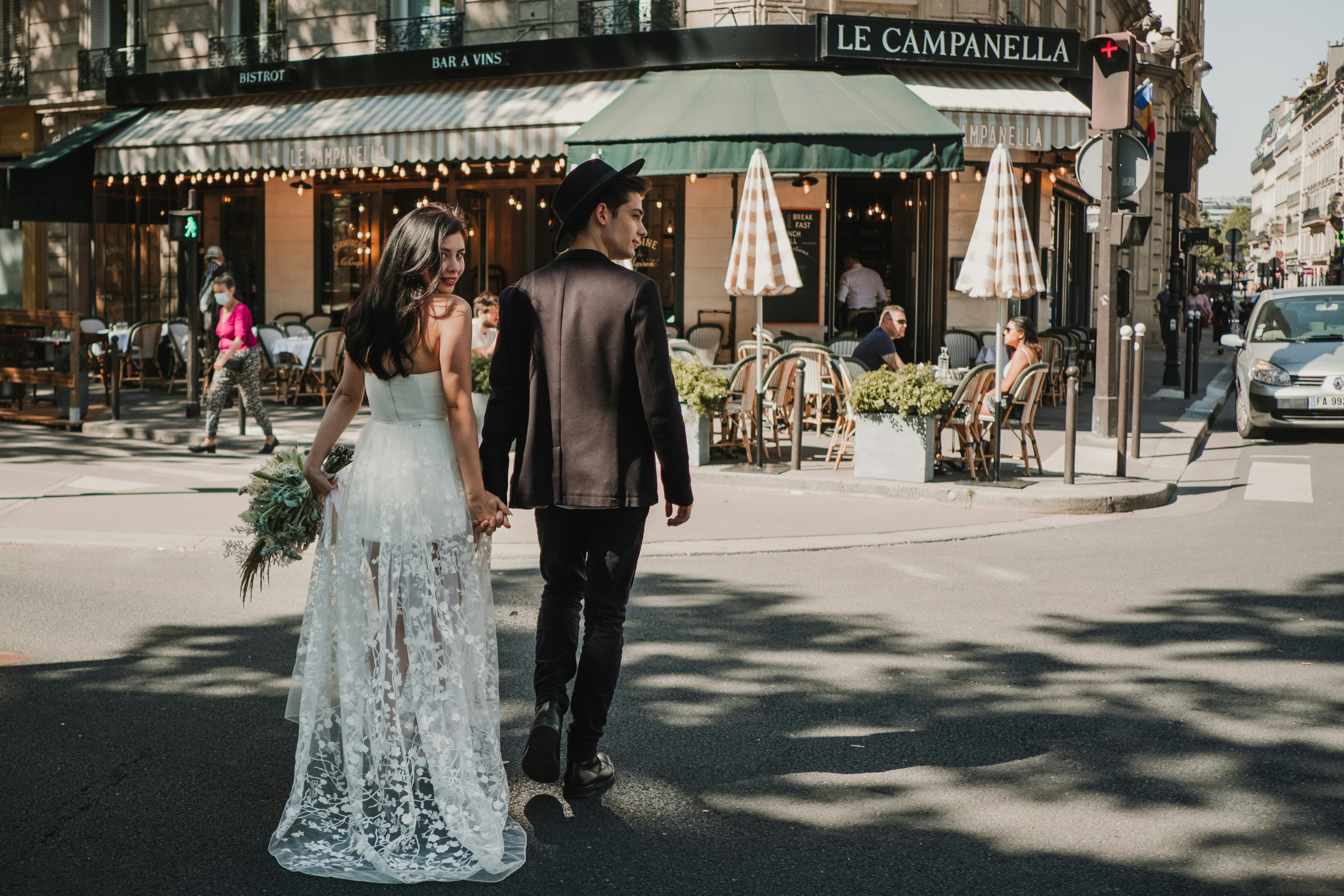 Wedding couple holding hands while walking in Paris streets for an elopement.