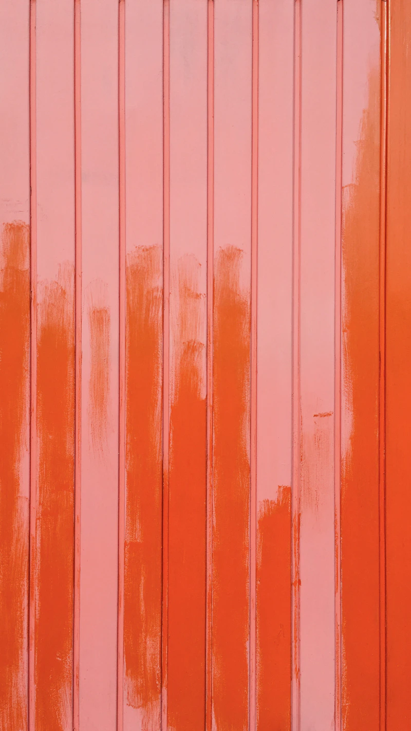 Close-up of a freshly painted textured orange wall