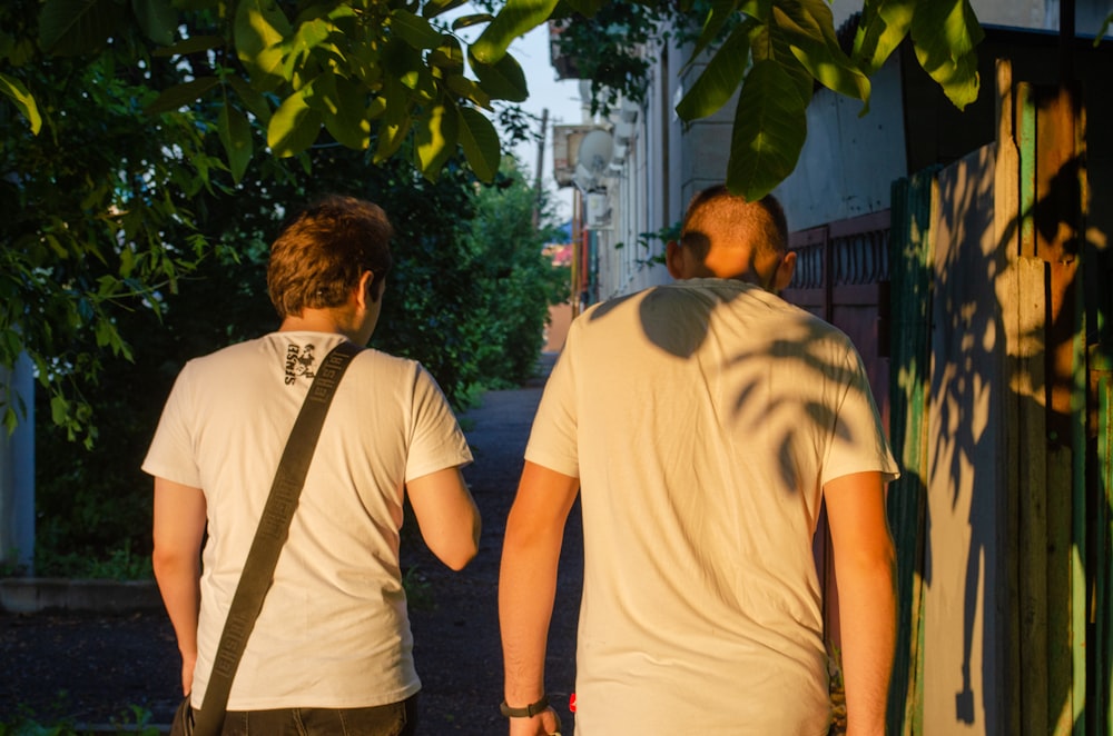 a couple of men walking down a street