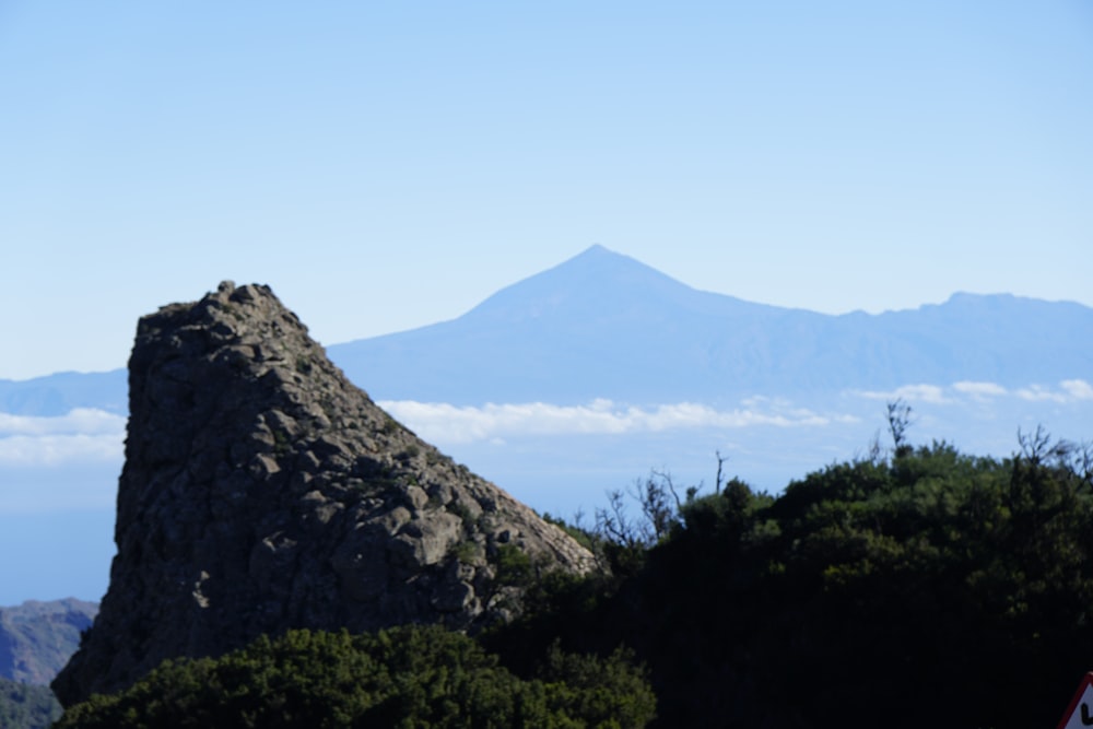 a view of a mountain with clouds in the background