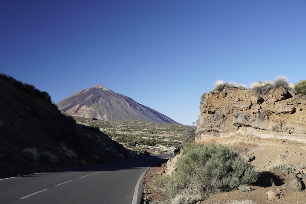 a road with a mountain in the background