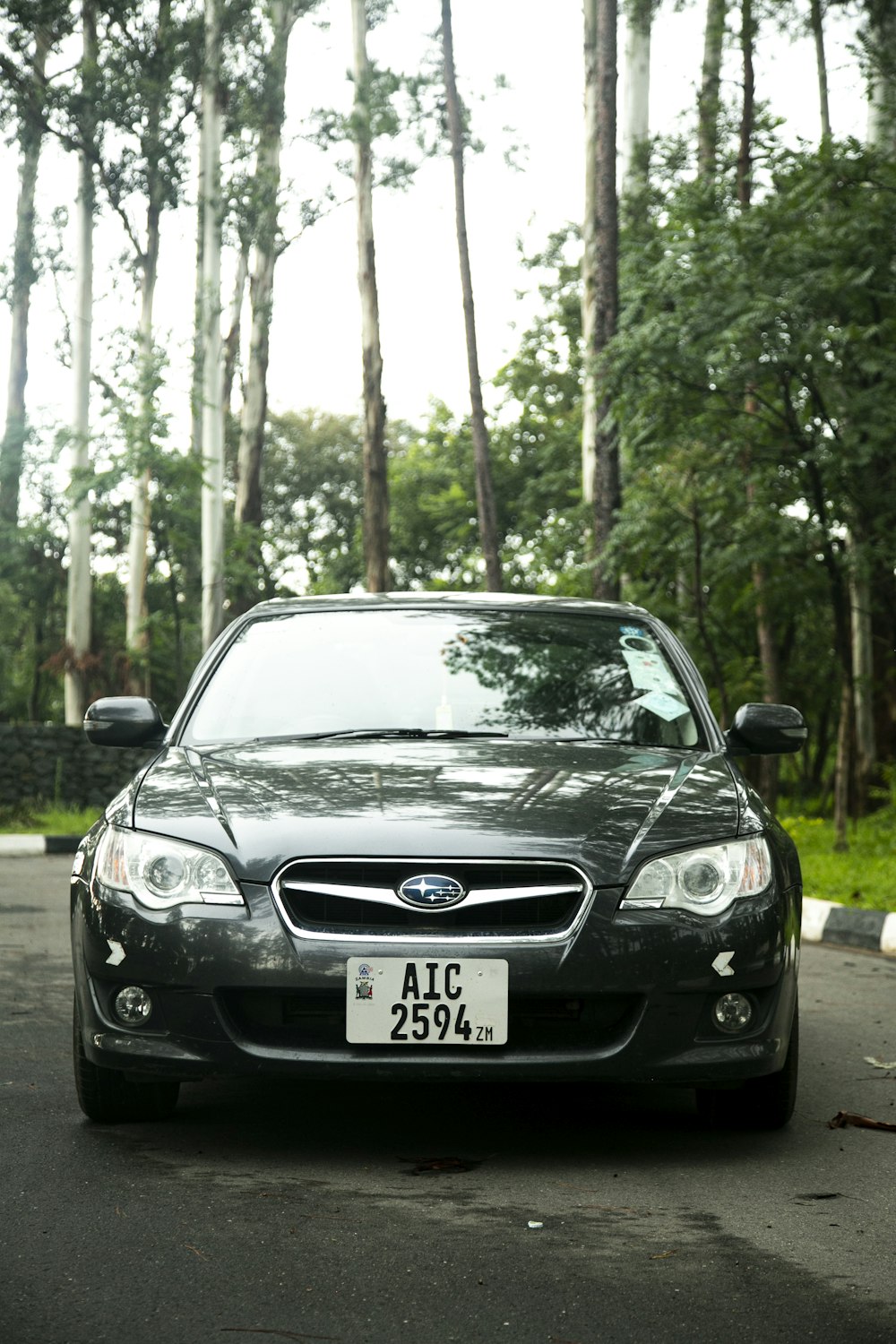 a black car parked on the side of the road