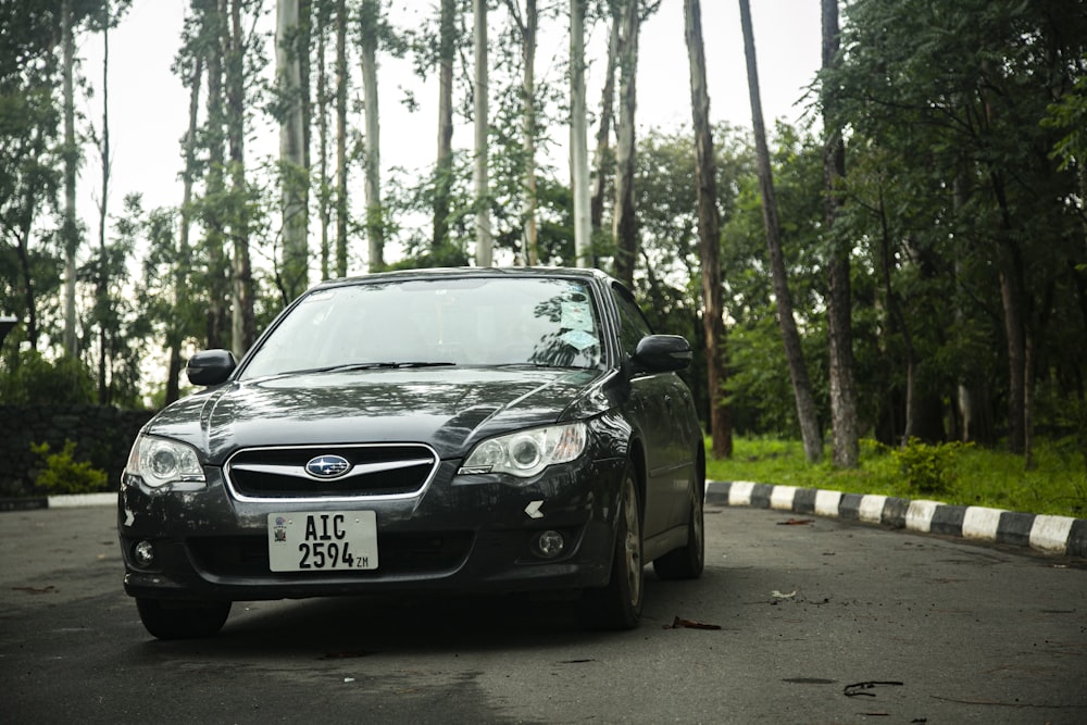 a black car parked on the side of the road