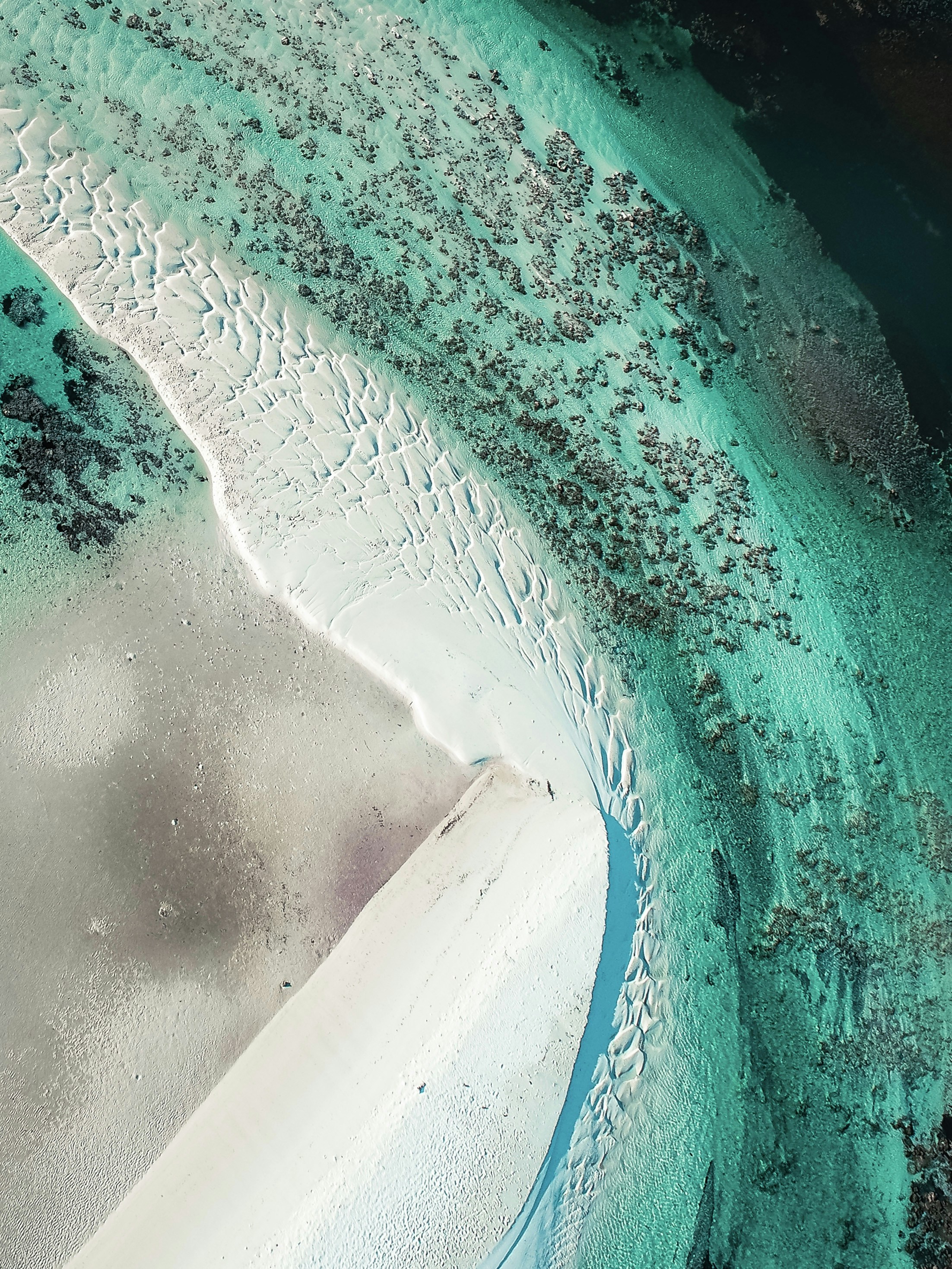 Aerial view of multiple small Bahamian cays surrounded by shallow turquoise water