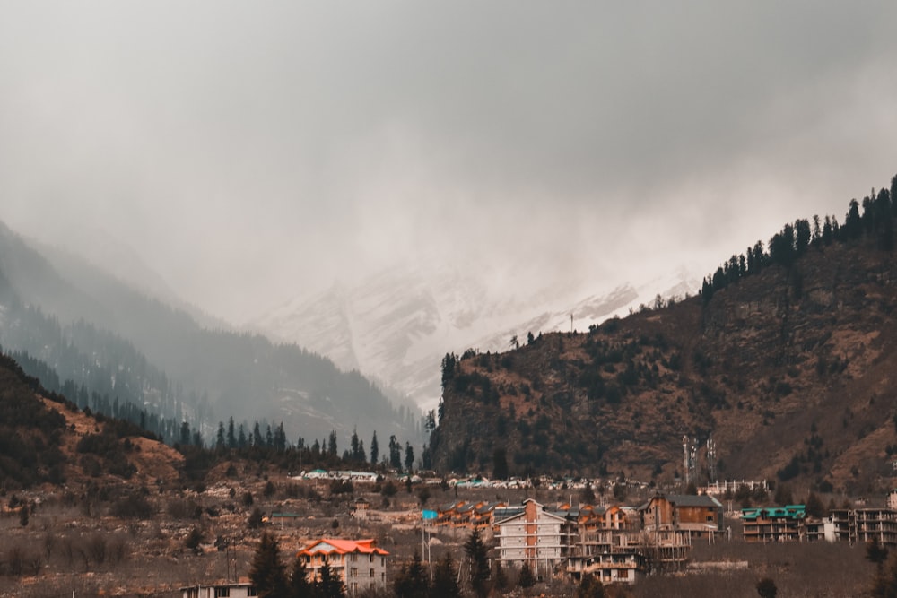 a view of a town in the mountains on a cloudy day