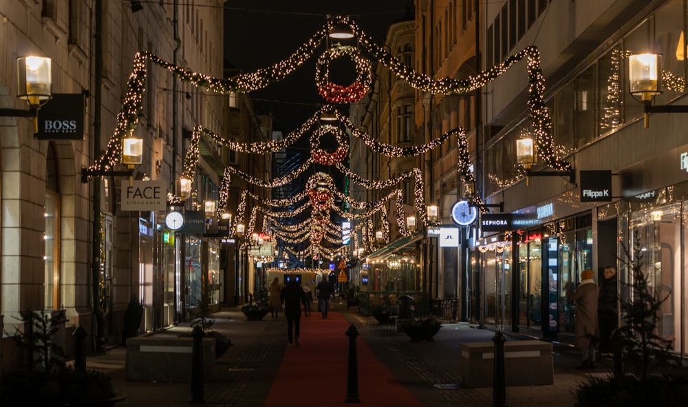 a city street is decorated with christmas lights