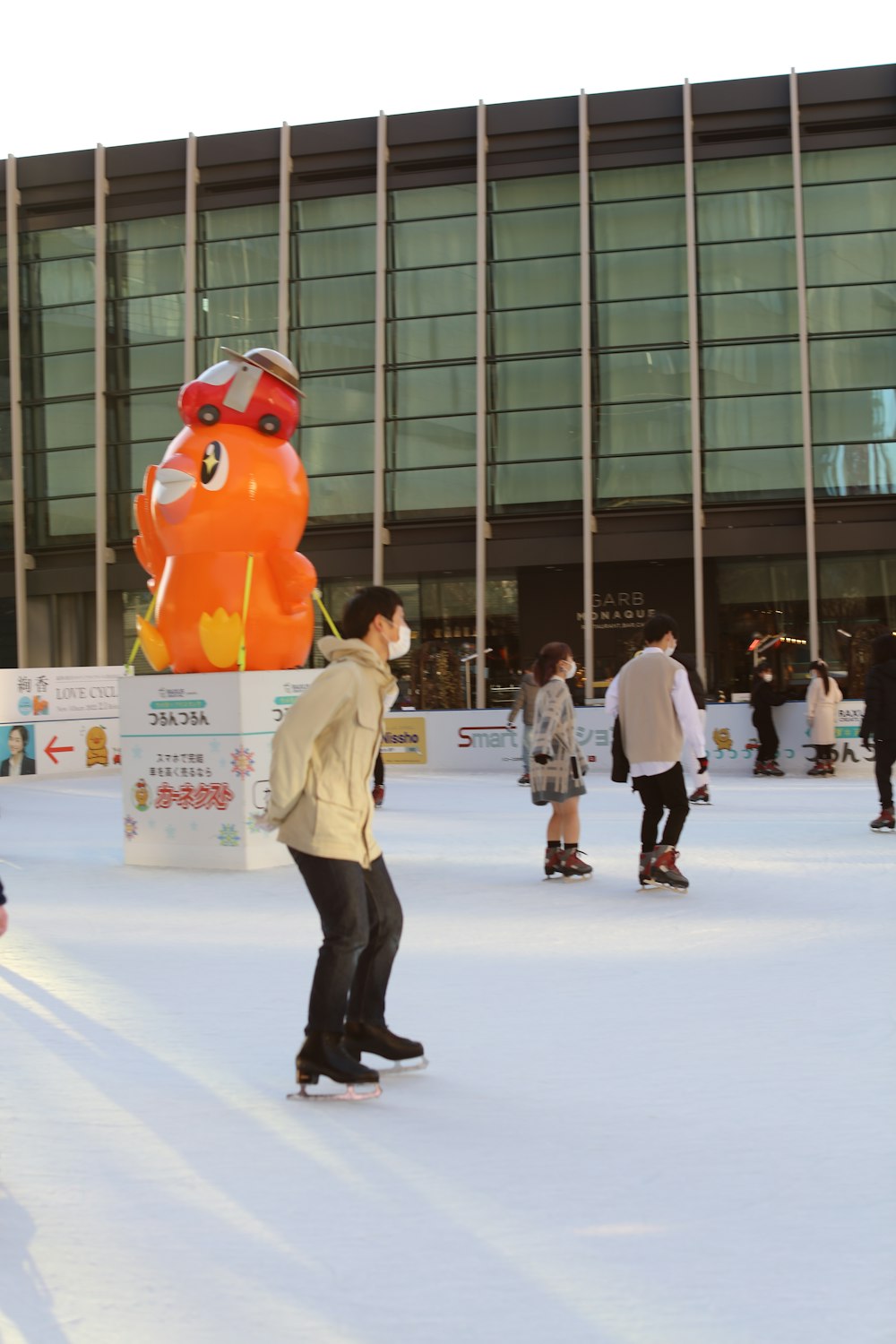 a group of people skating on an ice rink