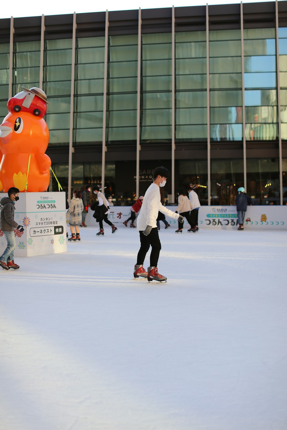 a group of people skating on an ice rink