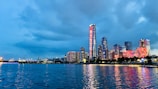 City skyline at dusk with crimson hues reflecting off glass buildings.