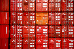a large amount of red containers stacked on top of each other