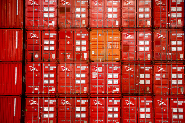 a large amount of red containers stacked on top of each other