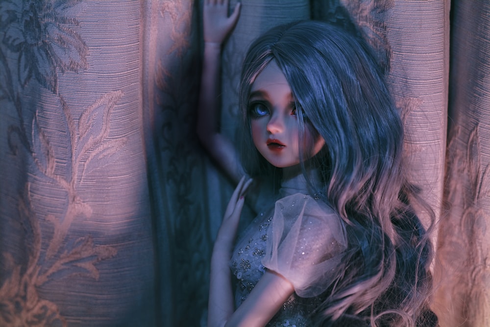 a close up of a doll near a curtain
