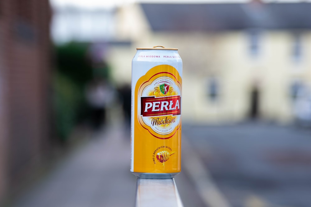 a can of perla beer sitting on top of a table