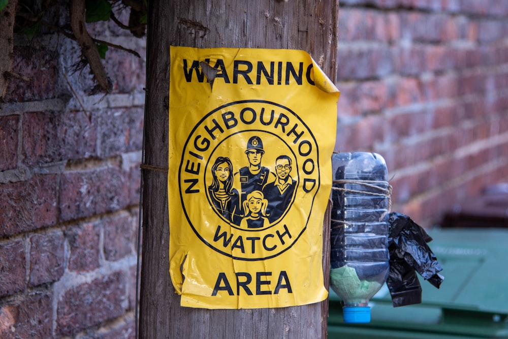 a sign on a telephone pole warning of neighborhood watch area