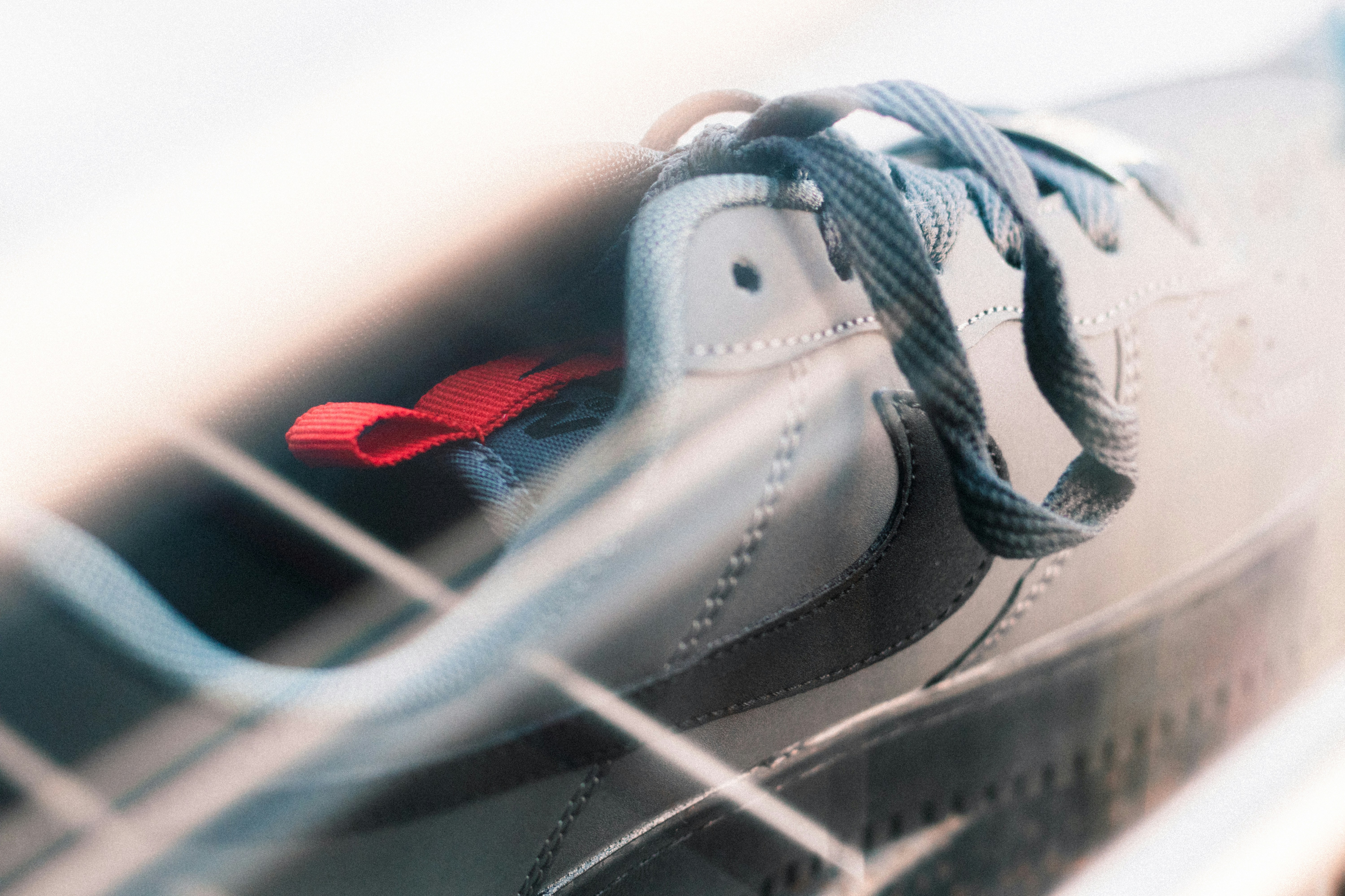 a close up of a shoe with a red shoelace