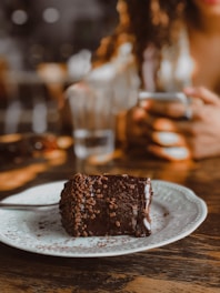 a piece of chocolate cake on a white plate