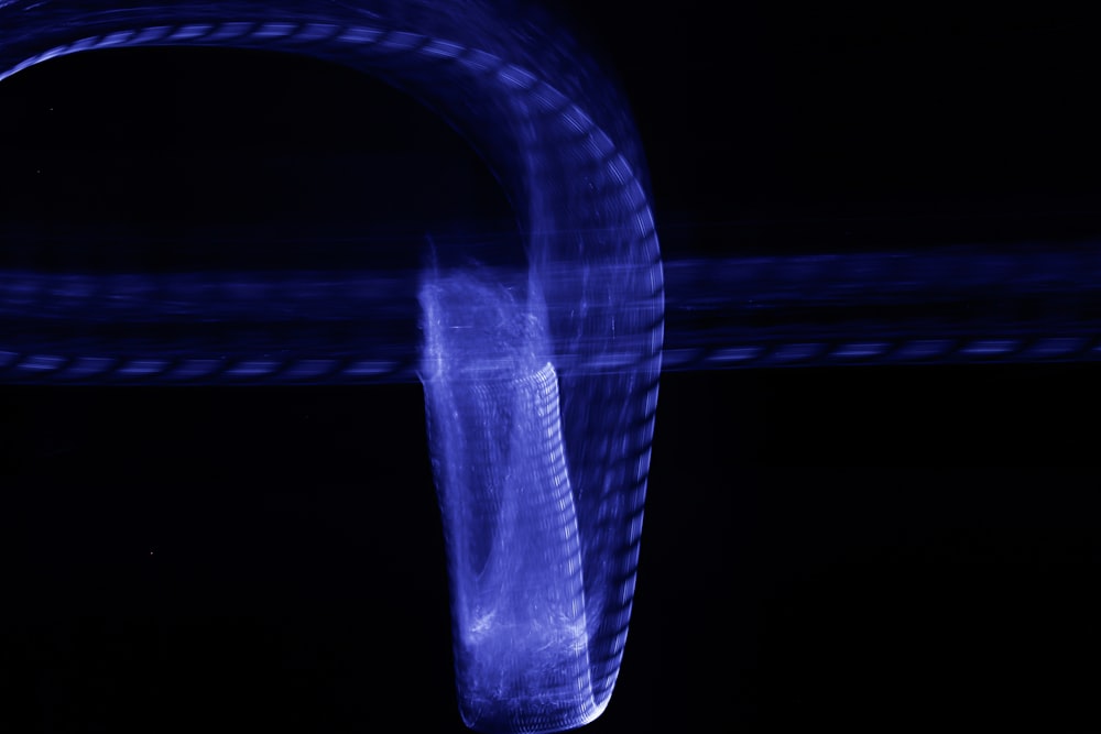 a close up of a blue object in the dark