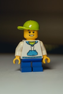 a lego man wearing a green hat and a white shirt