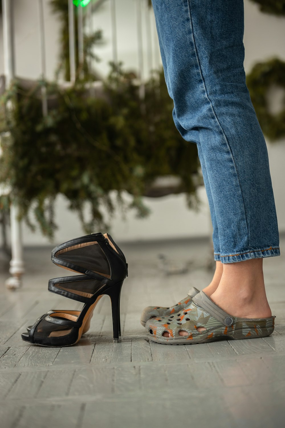 a woman standing next to a pair of shoes