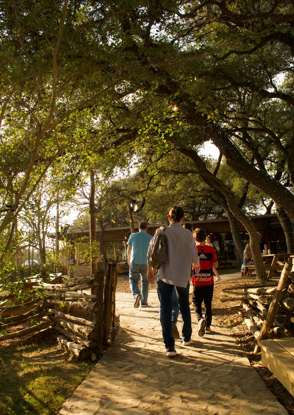 a group of people walking down a path