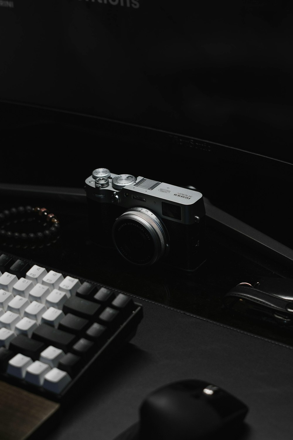 a camera sitting on top of a desk next to a keyboard