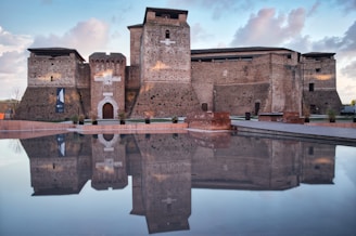 a large brick building sitting next to a body of water