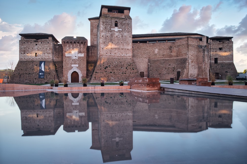 a large brick building sitting next to a body of water