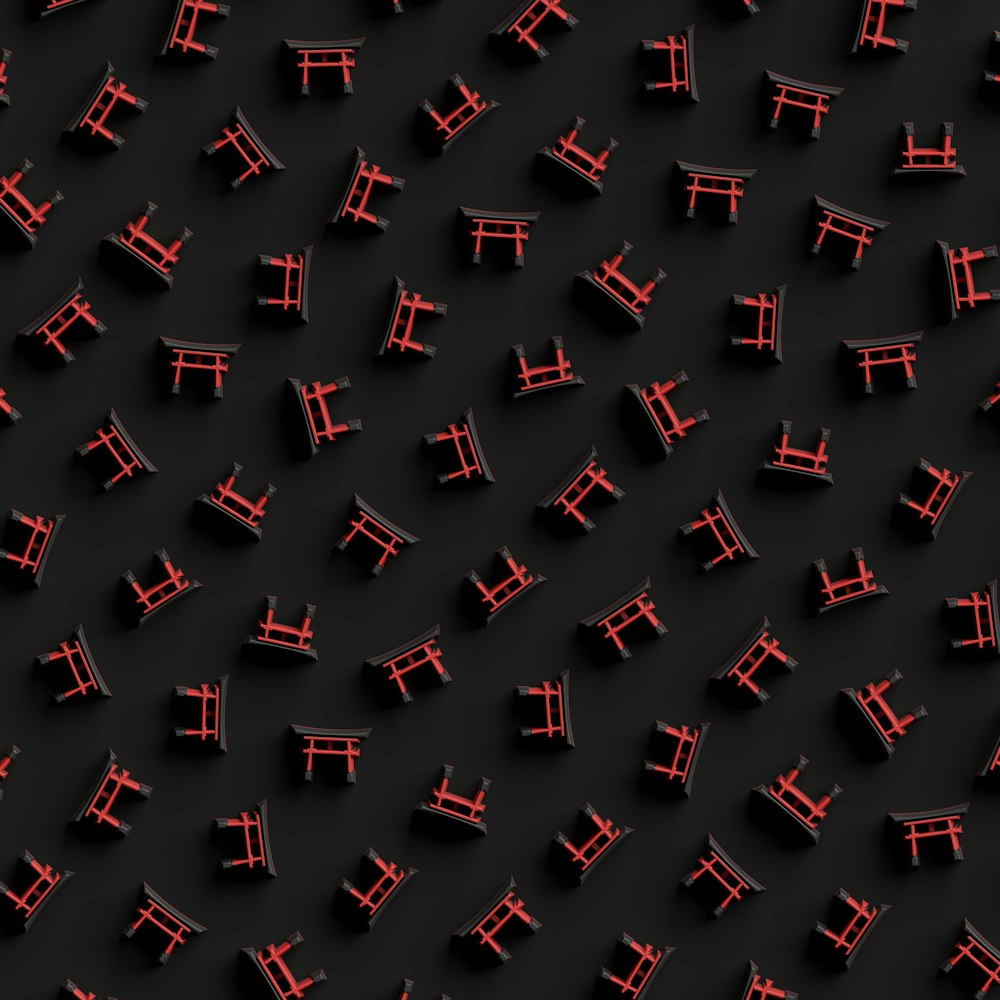 a group of red chairs sitting on top of a black surface