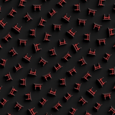 a group of red chairs sitting on top of a black surface