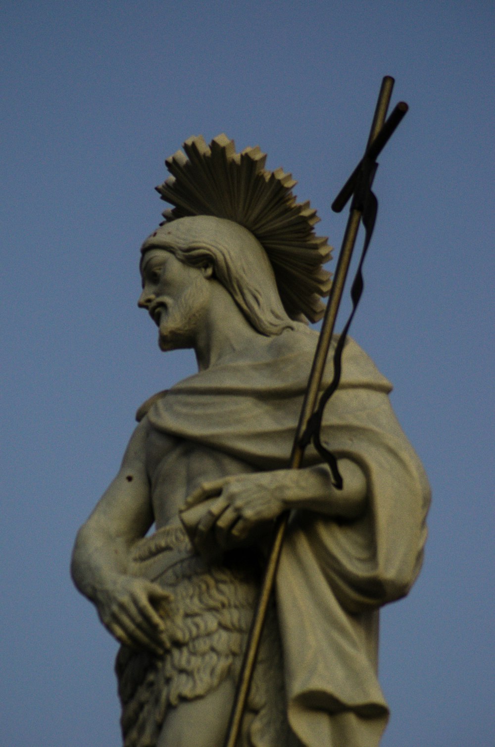 a statue of a man holding a spear