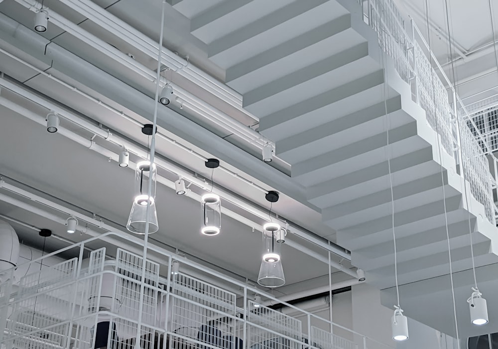 a group of lights hanging from the ceiling of a building