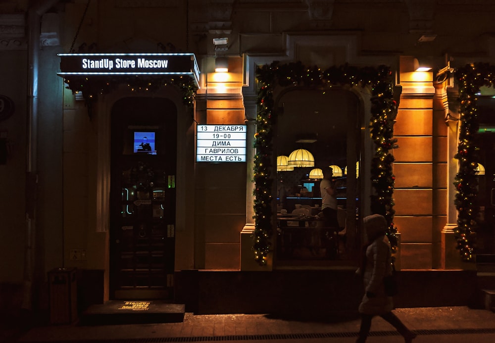 a person walking down a street at night