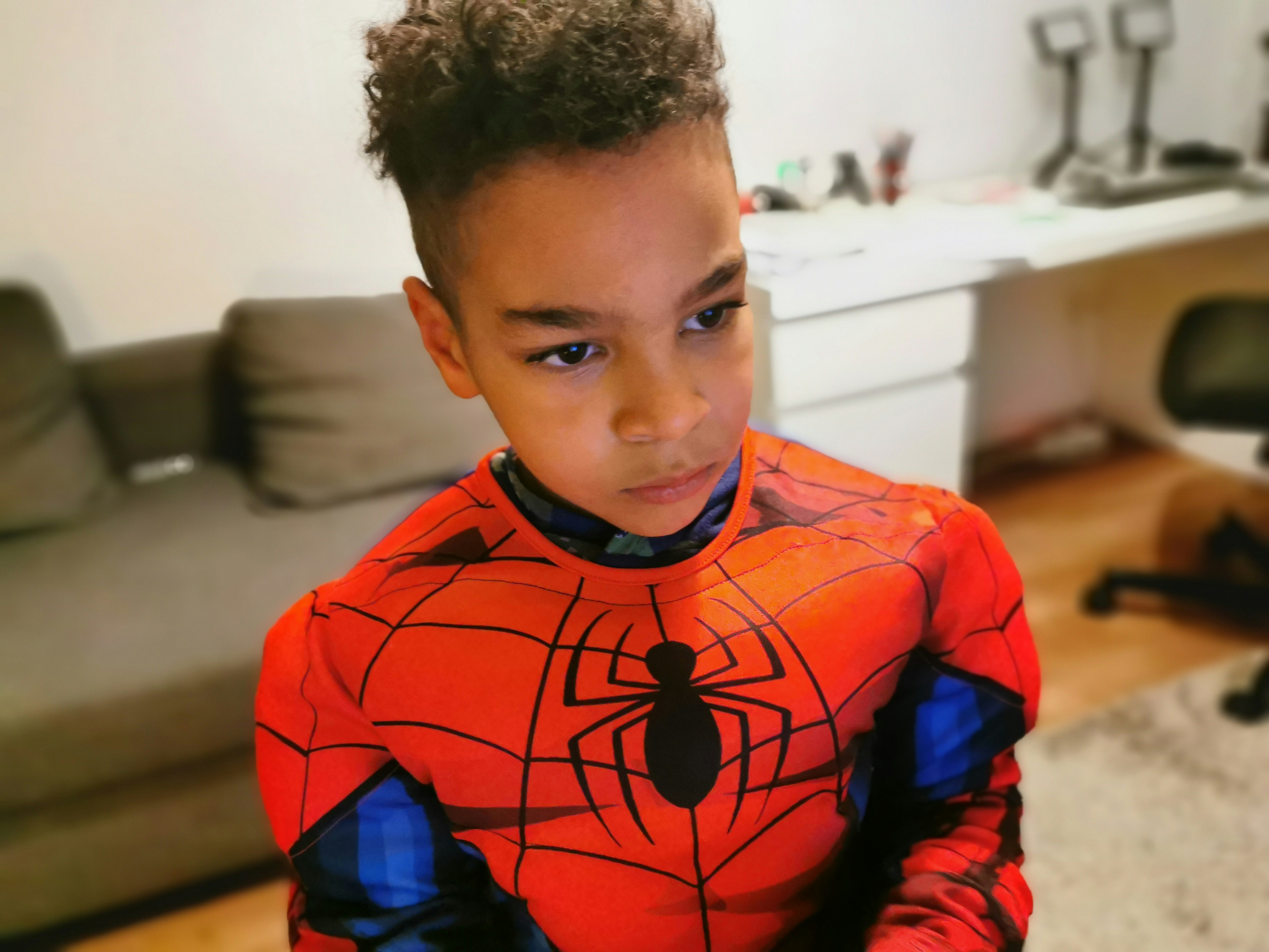 a young boy wearing a spider man costume