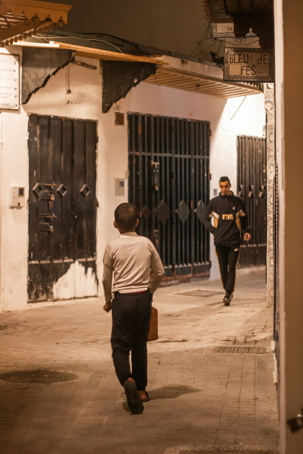 a couple of men walking down a street