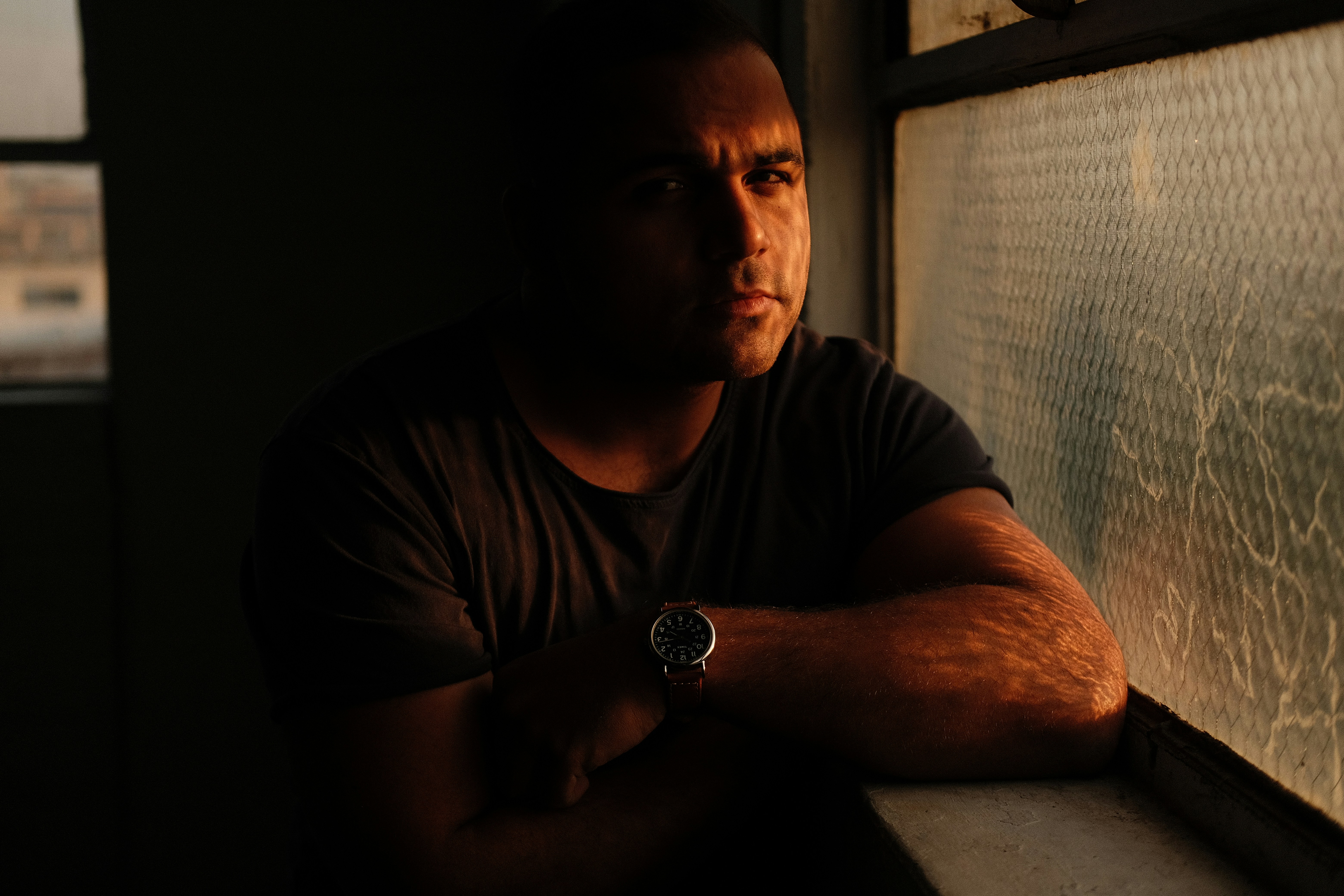 a man is looking out of a window