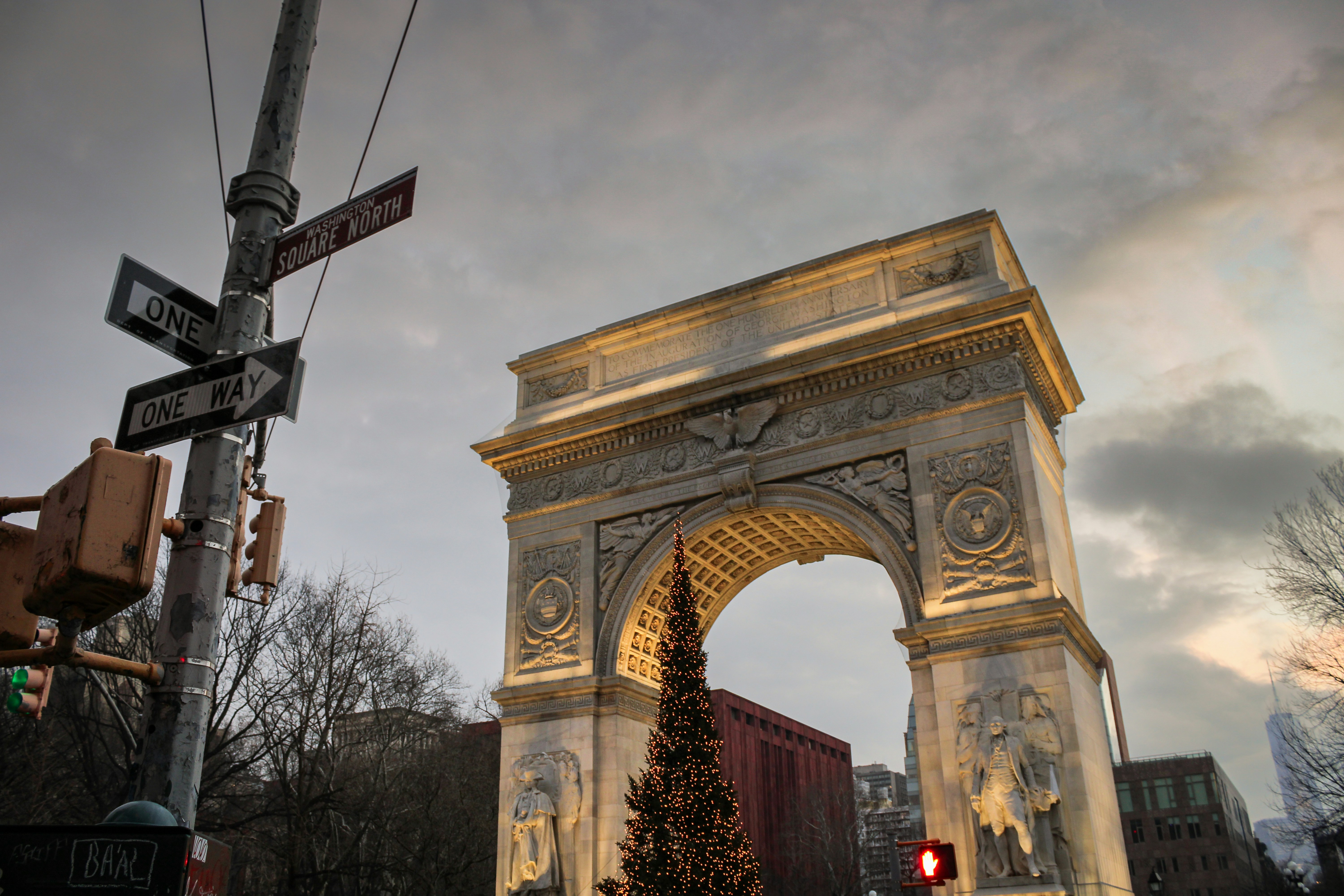 a large arch with a christmas tree in front of it