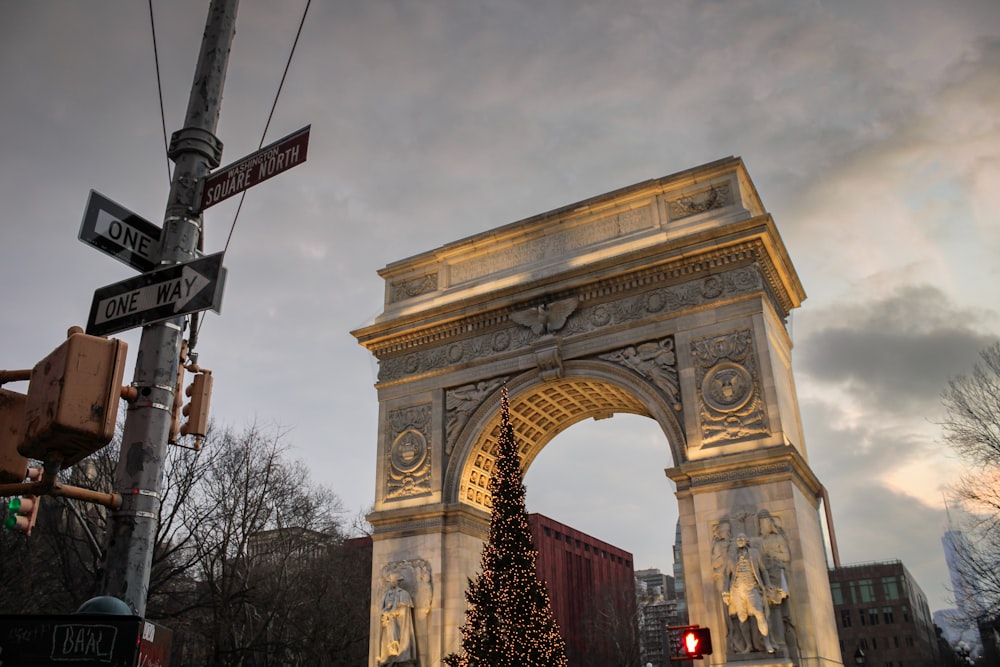 a large arch with a christmas tree in front of it