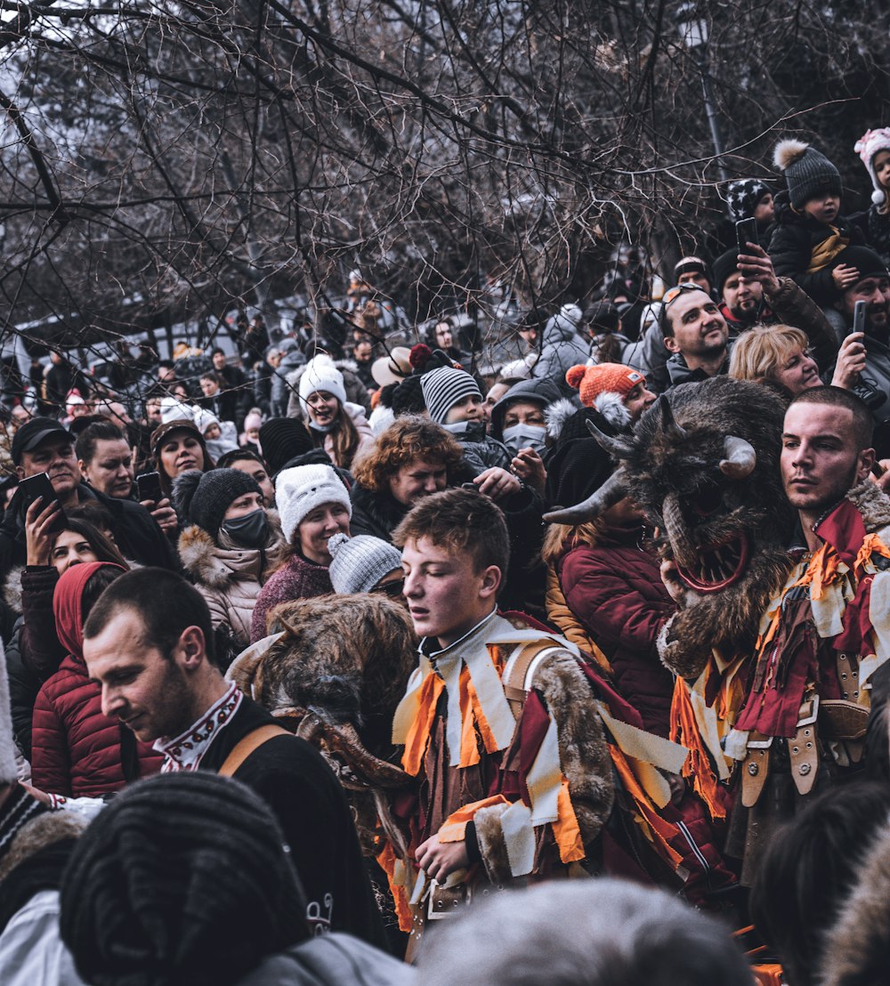 a crowd of people standing around each other