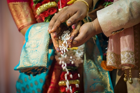 a close up of a person holding a bunch of beads