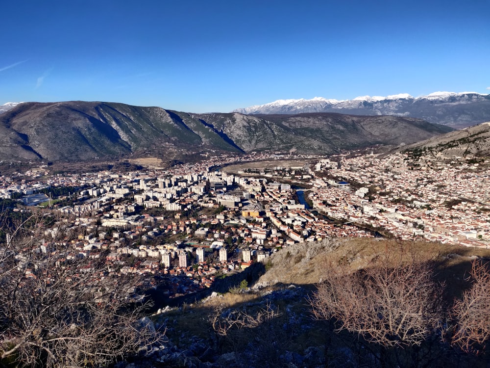 a view of a city with mountains in the background