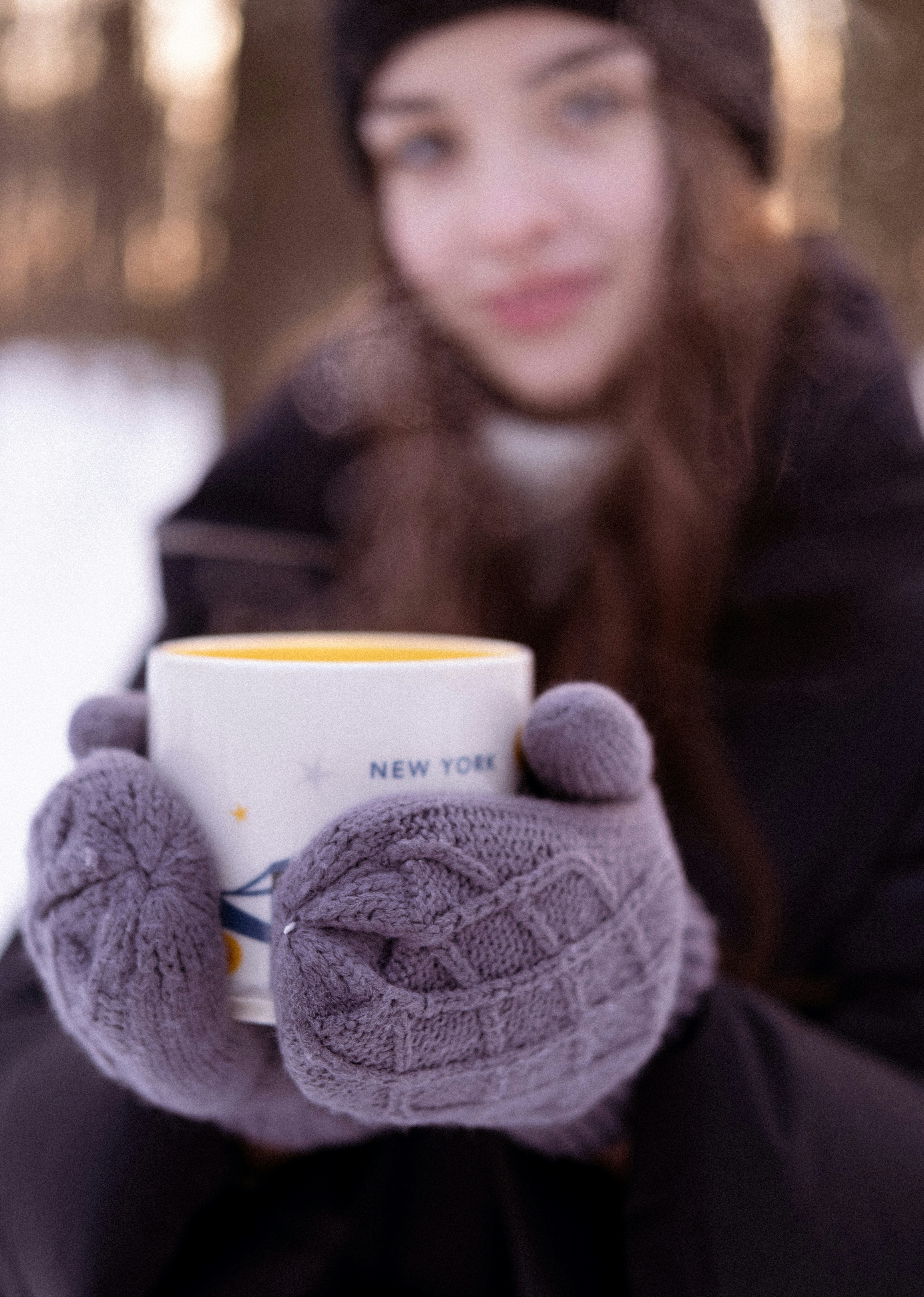 a woman holding a cup of coffee in her hands