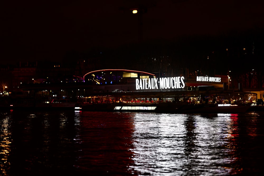 a large sign is lit up on the side of a building