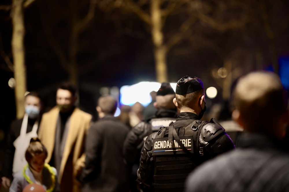 a police officer standing in front of a crowd of people