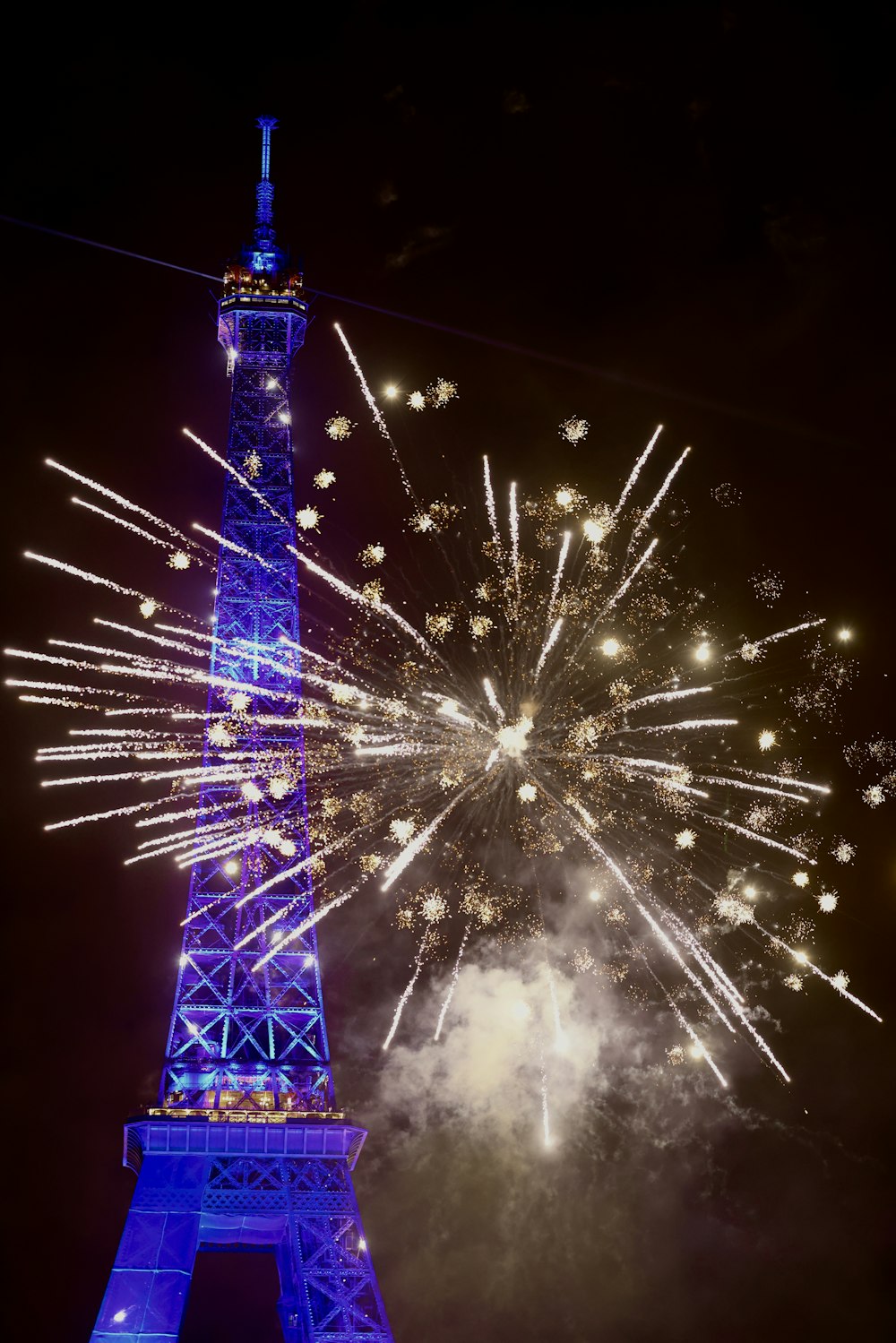 the eiffel tower is lit up with fireworks