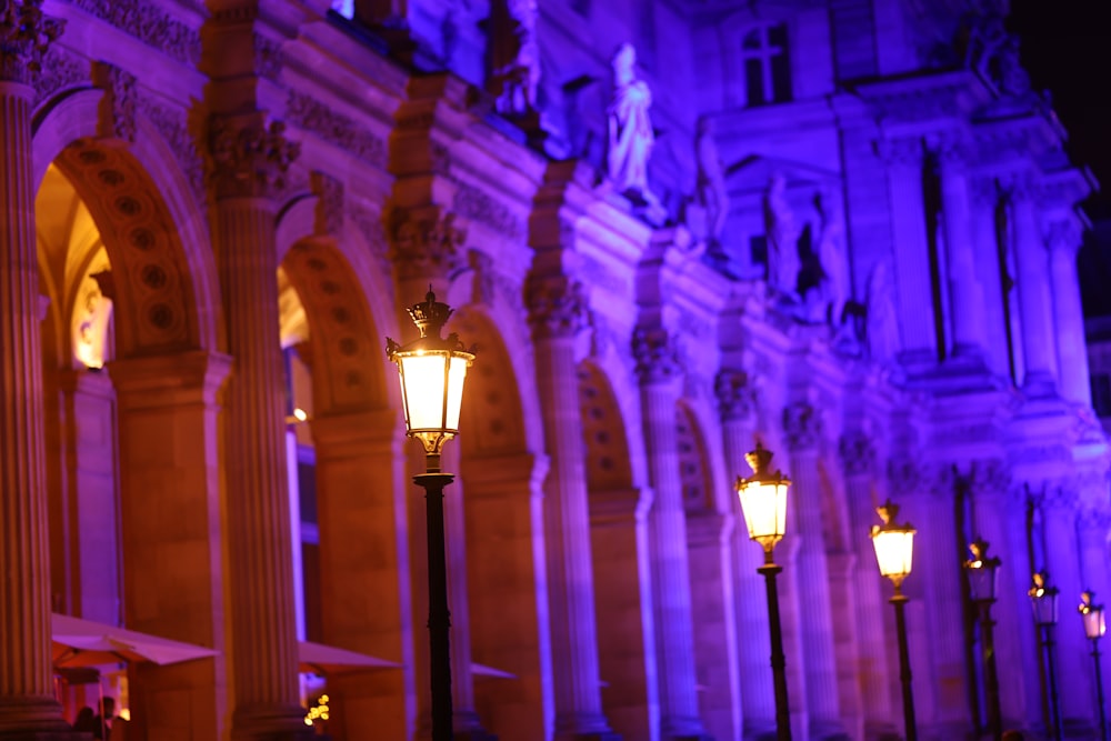 a couple of street lamps in front of a building