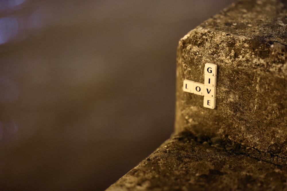 a close up of a cross on a stone wall