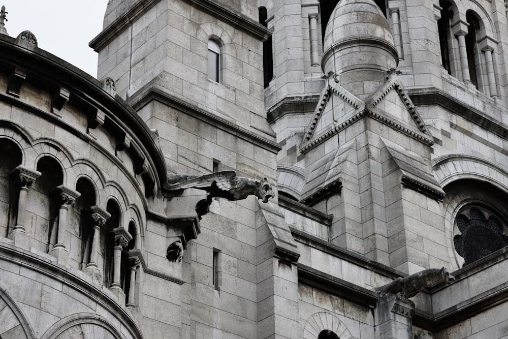 a large stone building with a clock on it's side