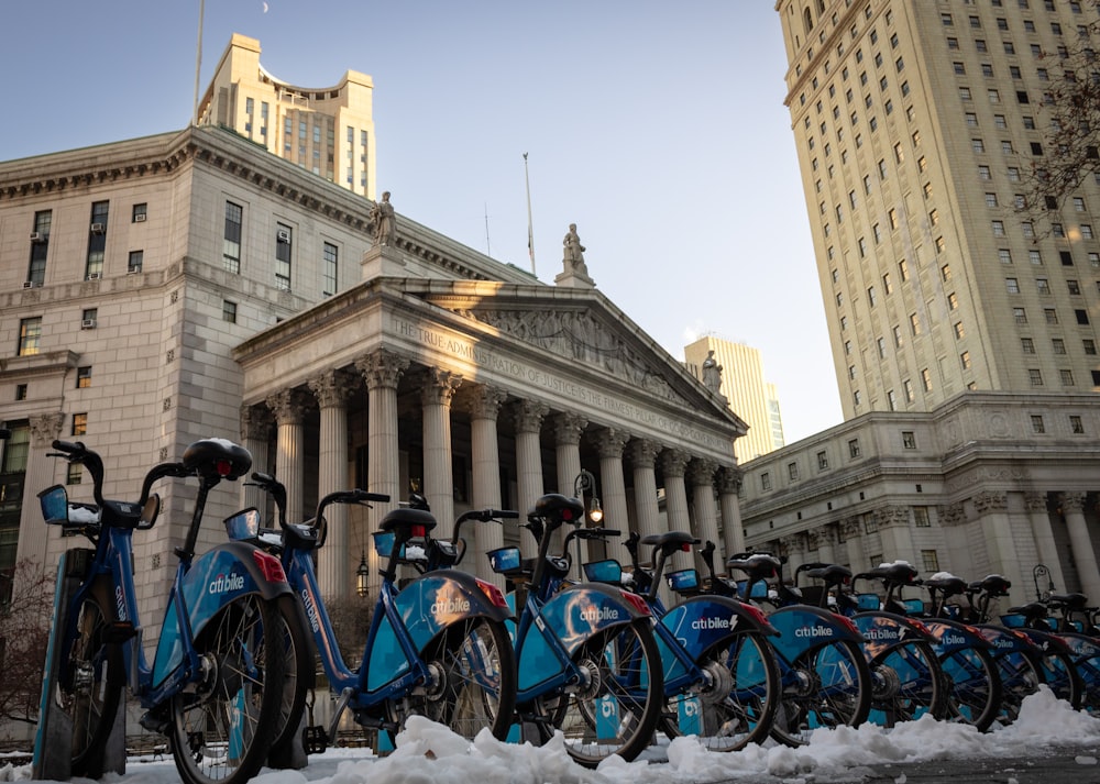 a row of bikes parked in front of a building